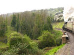 Locomotive 9351 pulls the 1615 from Bishops Lydeard to Minehead up the slope away from Watchet on the West Somerset Railway